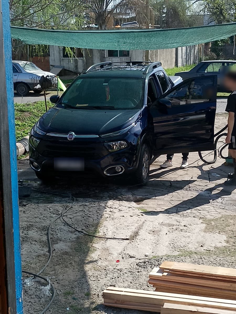 Una Fiat Toro azul con la puerta abierta bajo la media sombra